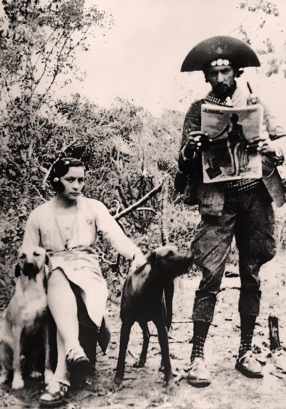 Maria e Lampião com os cães Guarani e Dourado. Ele mostra 
exemplar da revista 'A Noite Ilustrada'/ Foto: Benjamin Abrahão